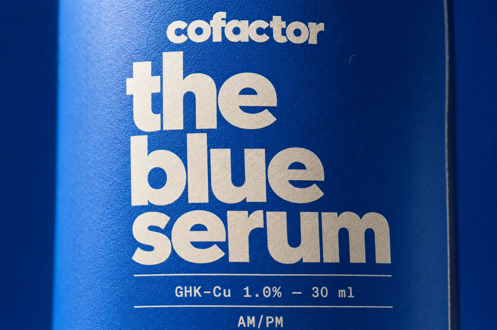 macro of the blue serum label: GHK-Cu 1.0%, 30 ml, AM/PM